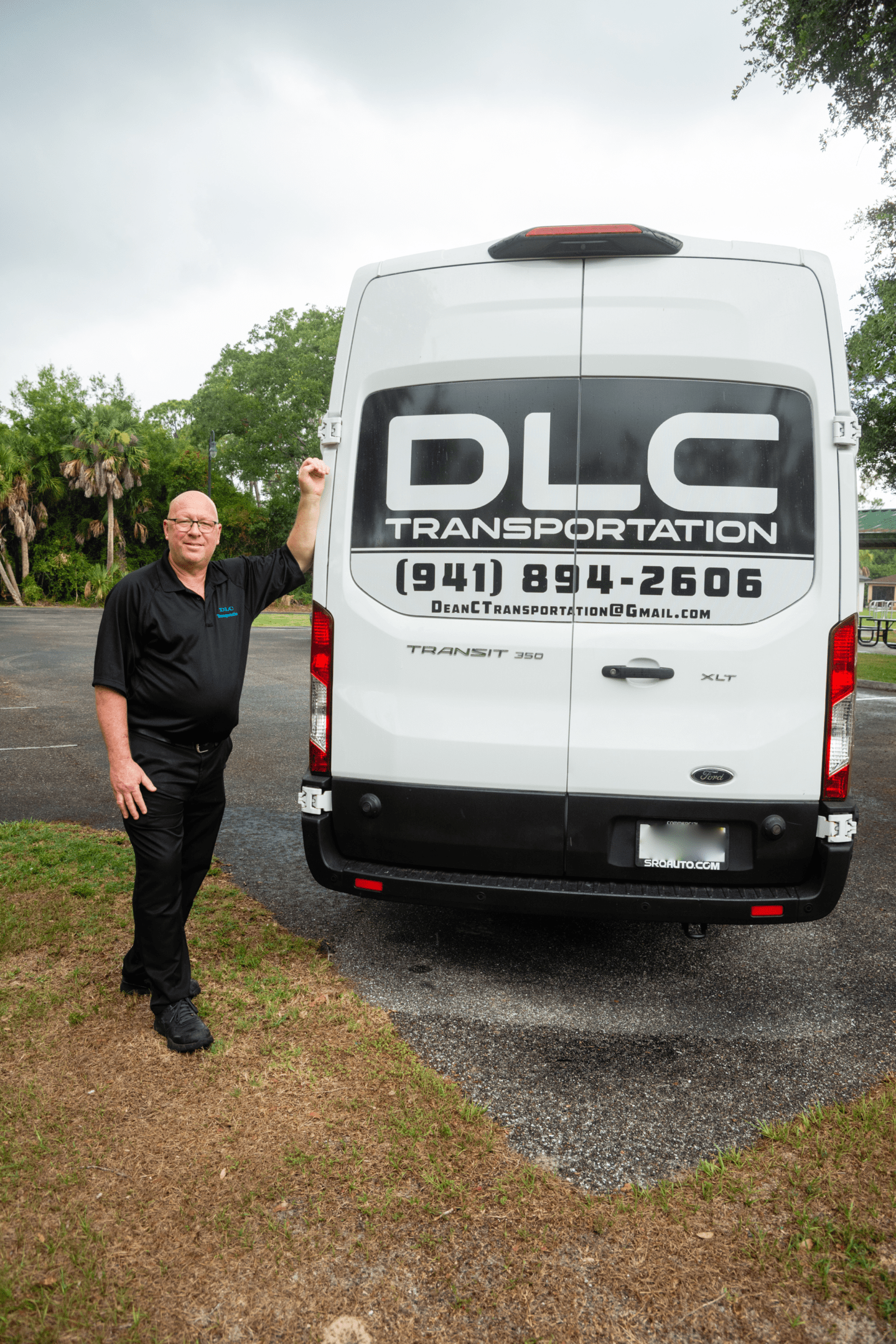 A man standing next to a white van.